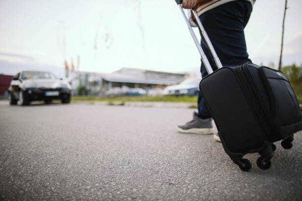 istock Man with suitcase is walking on the street 1205323730