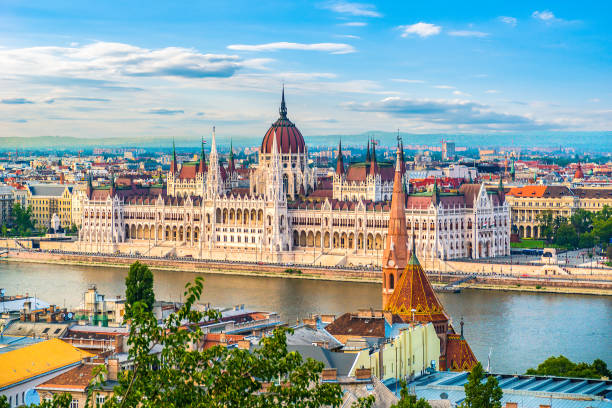 Hungarian Parliament at sunset Hungarian Parliament on Danube river in Budapest at sunset budapest stock pictures, royalty-free photos & images