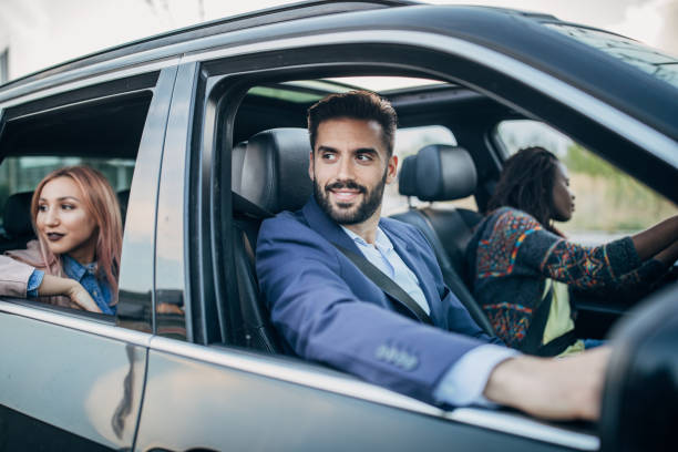 istock Cheerful friends traveling by a car 1205324959