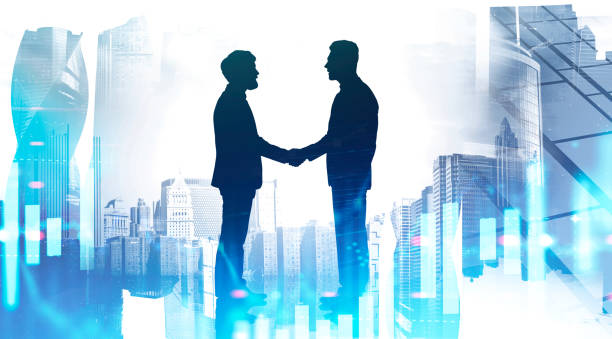 istock Businessmen shaking hands in city, graph 1205326141