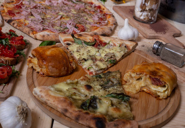 istock Wooden table with typical Neapolitan pizza slices. Isolated image 1205327121
