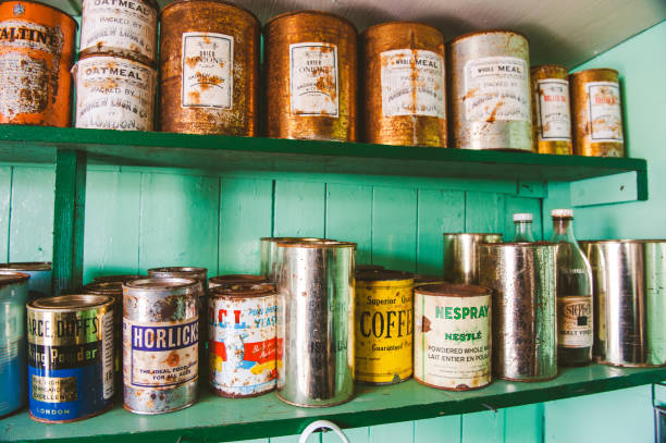 Port Lockroy, Antarctica - December 4, 2011,\nVarious vintage cans of supplies stacked on a shelf at Antarctica station Port Lockroy. Rusty cans of coffee, beans, oatmeal, etc.