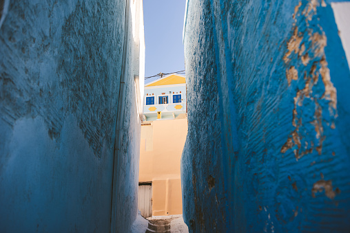 High blue walls of narrow street of village Menetes, Karpathos, Greece
