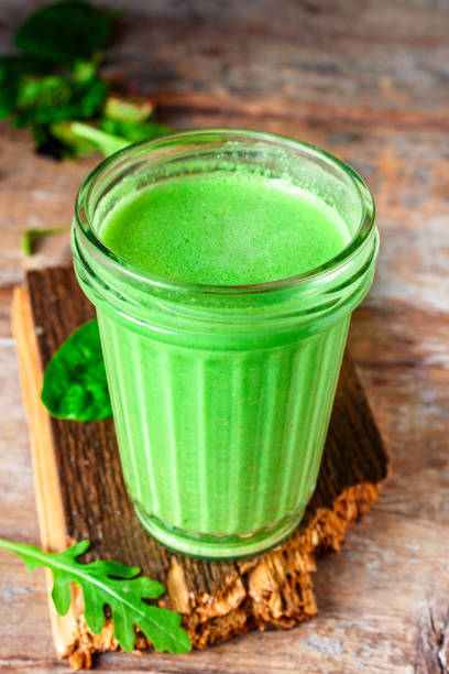 istock green smoothie cocktail antioxidant diet (organic fruit vitamins, vegetarian drink) menu concept background. top view. copy space 1205327319