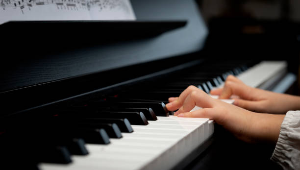 istock Little Girl Playing the Piano 1205328436