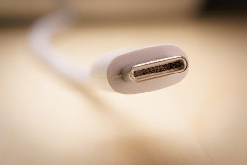 white USB Type C cable, selective focus and Macro shot. The EU will vote to force all smartphones to adopt USB-C as universal plug.