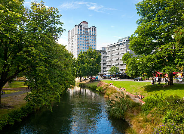 Christchurch cityscape with creek and green trees stock photo