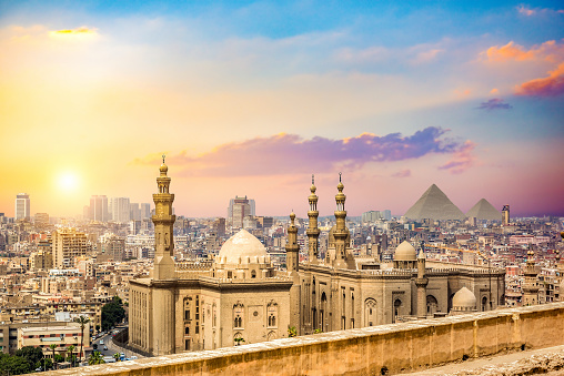 Sultan Hassan Mosque and cityscape of Cairo at sunset