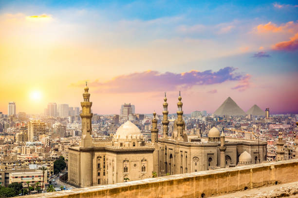 Sunset over Cairo Sultan Hassan Mosque and cityscape of Cairo at sunset egypt skyline stock pictures, royalty-free photos & images