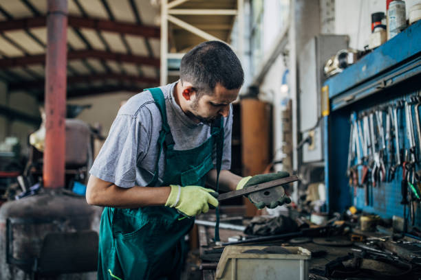 istock Young man working in metal factory 1205335154
