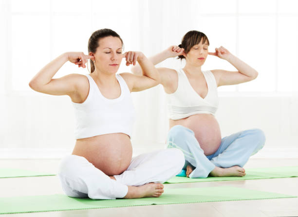 istock Pregnant women doing yoga 1205335157
