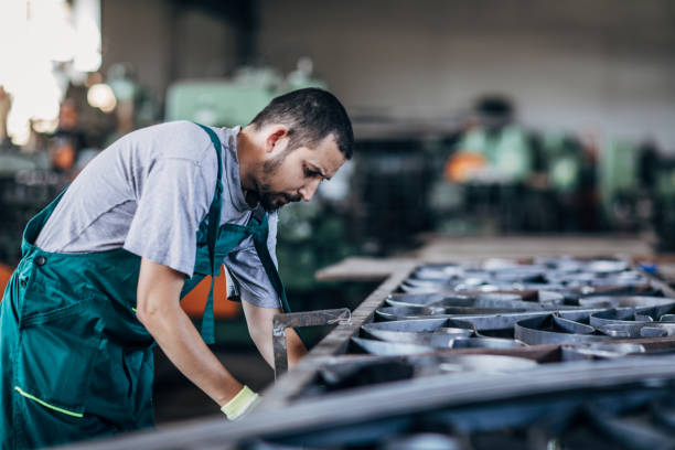 istock Young man working in metal factory 1205335569