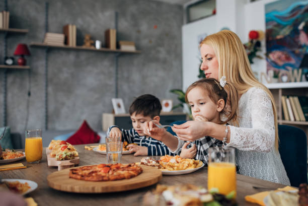 istock Mothers and kids eats tasty food 1205339574