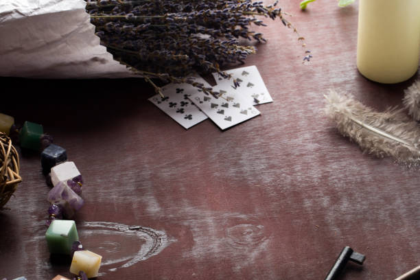 istock Divination with white candles, lavender, stones, feathers and cards. 1205341976