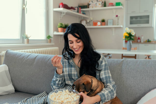 istock Watching Tv With Her Pet Dog 1205342799