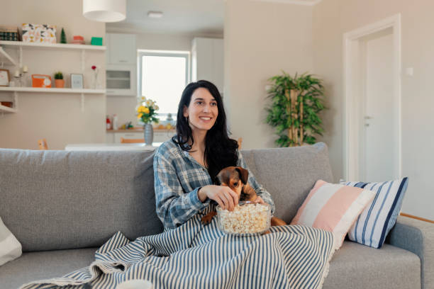 istock Young Woman Watching TV 1205342813