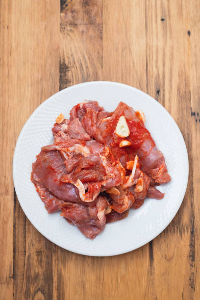 istock raw meat with herbs and garlic for grill on dish 1205343019