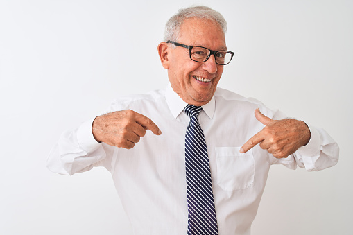 Senior grey-haired businessman wearing tie and glasses over isolated white background looking confident with smile on face, pointing oneself with fingers proud and happy.