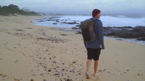 istock Beach relaxation.Young man looking at sea 1205344626
