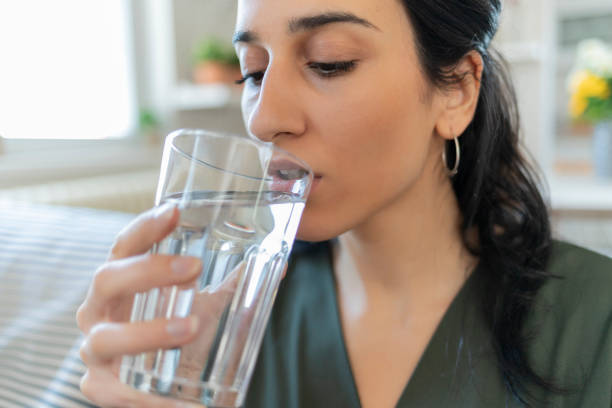 istock Woman Drinking Glass of Water 1205344653