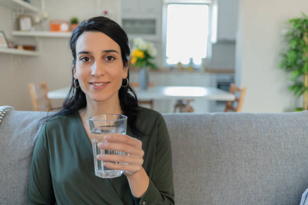 istock Woman Drinking Glass of Water 1205344895