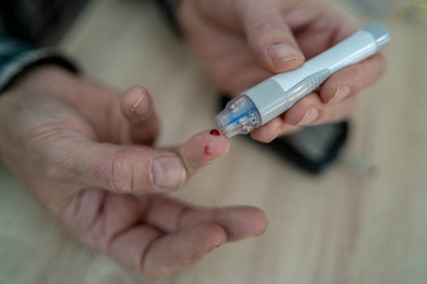 istock Senior man doing blood sugar test at home 1205345131