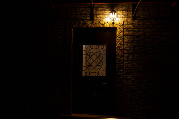 Retro style street lamp shines on a brick wall