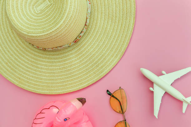 istock Summer beach composition. Minimal simple flat lay with plane sunglasses hat and Inflatable flamingo isolated on pastel pink background. Vacation travel adventure trip concept. Top view copy space 1205353361