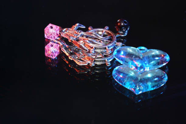 istock Colorful glass beads on mirrored surface photographed in studio 1205353392
