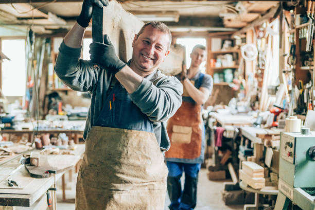 istock Carpenters carrying a wood plank 1205353623