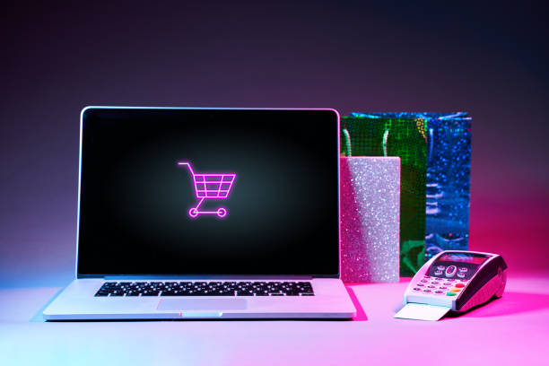 istock Laptop, gift packet, and pin pad on the table in modern neon colors. 1205354880