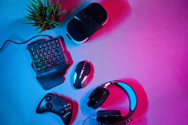istock Keyboard, mouse, gamepad, virtual reality headset and headphones. 1205356099