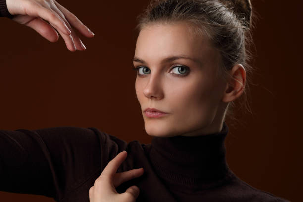 istock Beautiful girl in a maroon turtleneck on a brown background 1205356143
