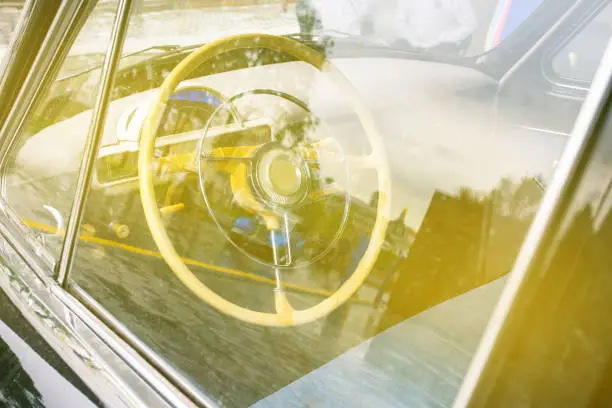 Steering wheel of a retro car. Vintage transport. The interior of the car.