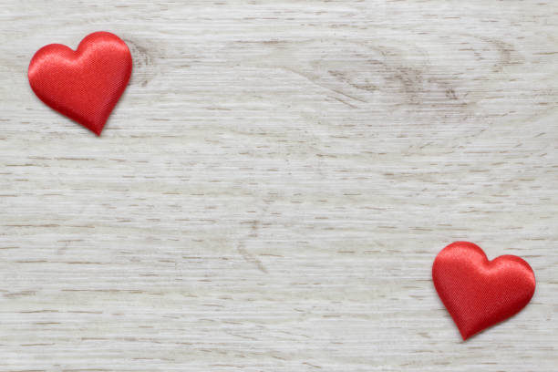 istock Wooden background with two hearts 1205356549