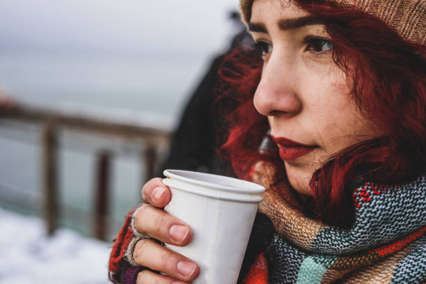 Unhappy And Thoughtful Woman Cools and Drinks Coffee