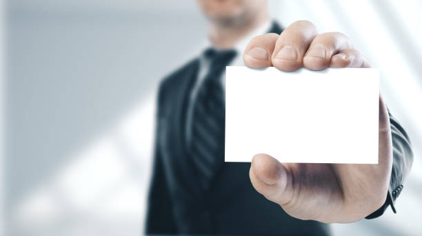 istock Businessman holding a white business card 1205359516