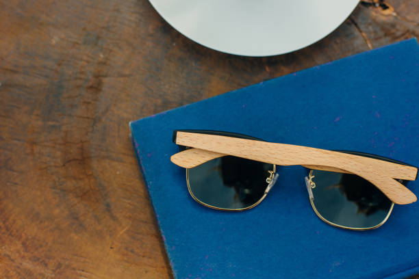 istock sunglasses on a table with a blue book and a cup of coffee 1205359660