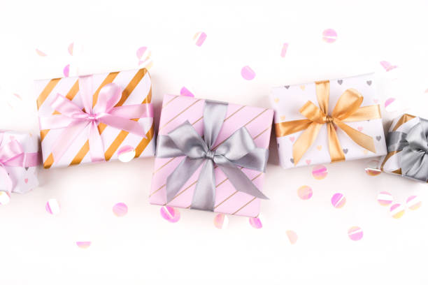 istock Set of gift boxes with bows and confetti on a white background. 1205359732