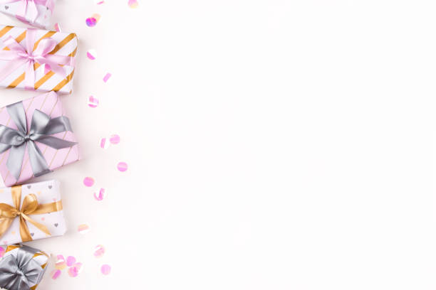 istock Set of gift boxes with bows and confetti on a white background. 1205359834