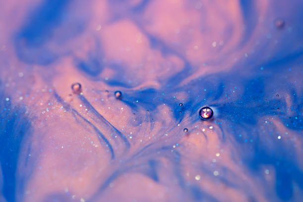 istock blue and pink alcohol ink with glitter dissolved in water, abstract background, macro view 1205360855