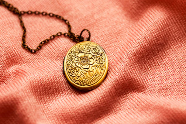 istock old vintage grandma's bronze locket on a pink fabric texture 1205361166
