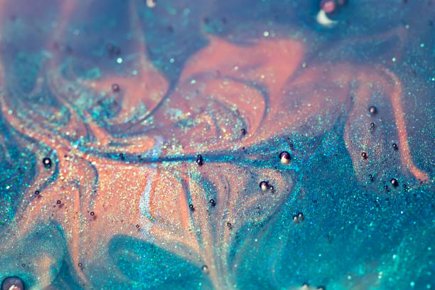 istock blue and pink alcohol ink with glitter dissolved in water, abstract background, macro shot 1205361912