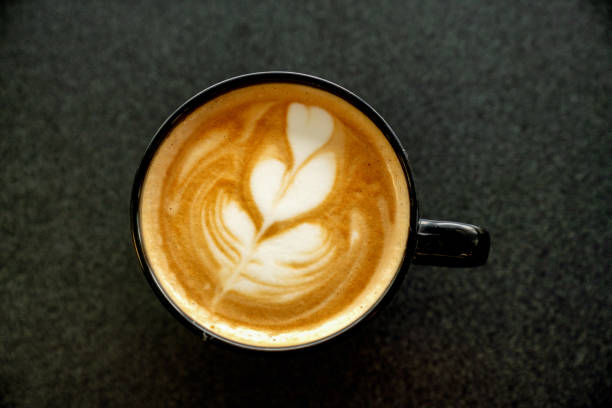 istock A Deliciously Decorated Frothy Cappuccino On A Black Table 1205363213