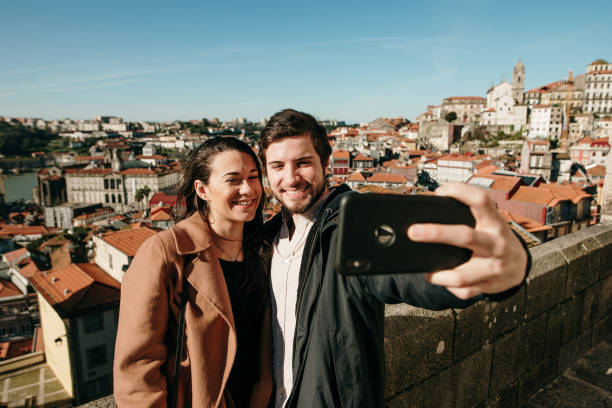 istock Young couple taking a selfie picture with a modern smartphone 1205366106