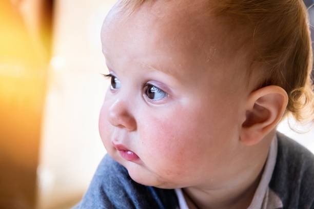 istock Baby boy headshot looking away 1205366417