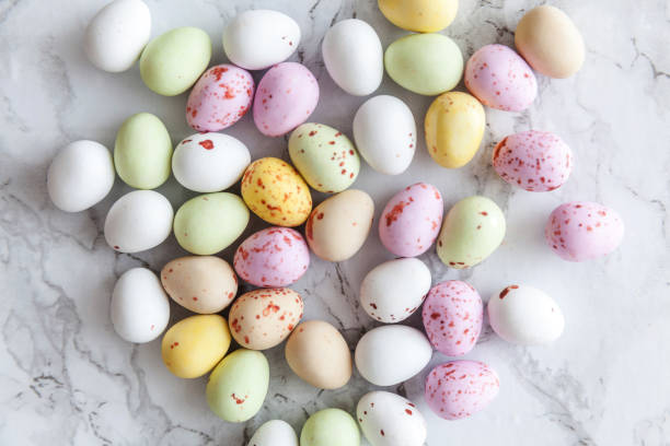 istock Happy Easter concept. Preparation for holiday. Easter pastel candy chocolate eggs sweets on trendy gray marble background. Simple minimalism flat lay top view copy space 1205366691