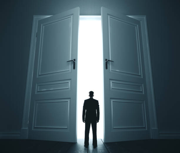 istock Businessman in room with open door. 1205368196