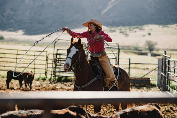 istock Adult cowboys riding galloping horses 1205368411