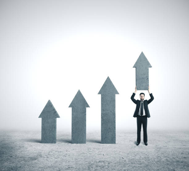 istock Businessman holding concrete arrow. 1205369038